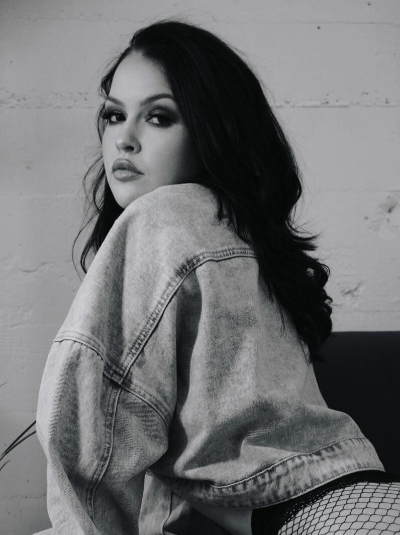 Heather Grace Hancock Dramatic black and white close-up of a woman in a denim jacket, glancing over her shoulder.